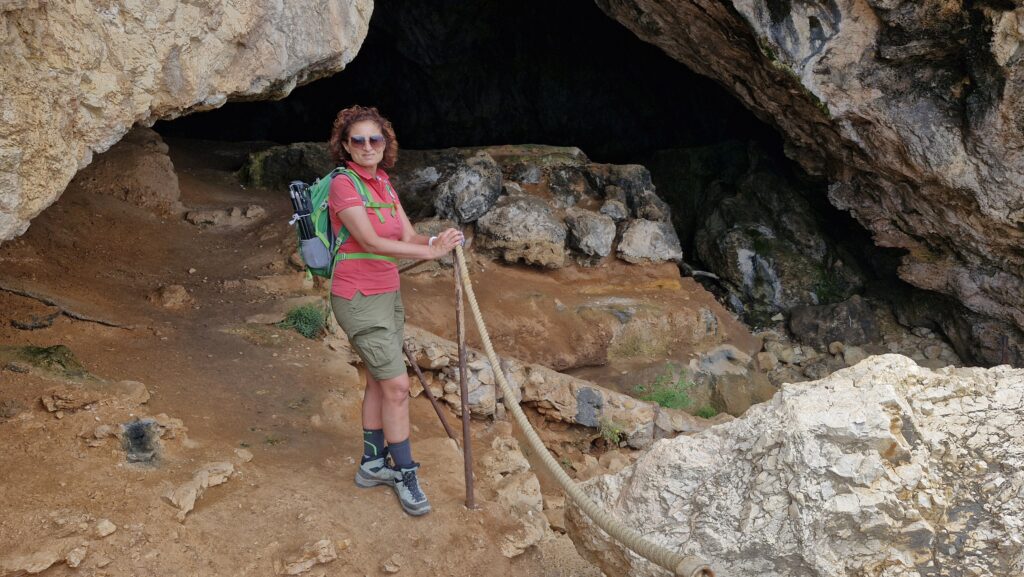 Donna vestita da trekking all'entrata di una grotta per i migliori consigli di trekking
